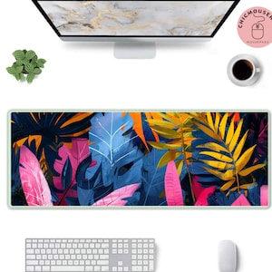 May include: A colourful abstract mouse mat with a tropical leaf design. The mouse mat features a variety of colours, including pink, blue, yellow, and green. The leaves are arranged in a random pattern, creating a visually appealing and modern design.