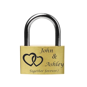 May include: A gold padlock with the inscription "John & Ashley Together forever!" and two intertwined hearts.