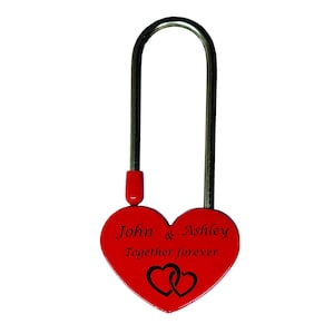 May include: A red heart-shaped padlock with the names "John & Ashley" and the phrase "Together forever" engraved on it. The padlock has a silver metal loop and a red stopper.