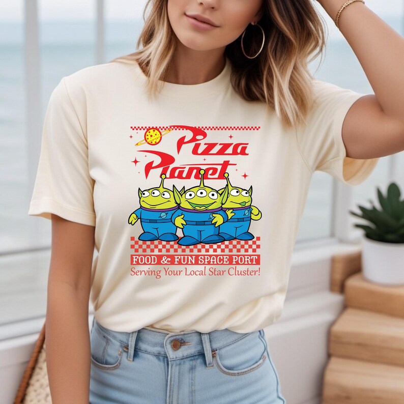 a woman wearing a pizza planet t - shirt