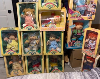 Lot of Vintage cabbage patch dolls 1983-1990  Total of 13 dolls new in box intact accessories and birth certificates.