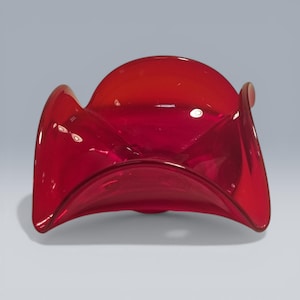 May include: A striking red glass bowl with a distinctive, curved form. The bowl has a rounded top and sides that gently curve outwards, creating an appealing shape. The transparent glass allows light to pass through, enhancing the rich red colour.