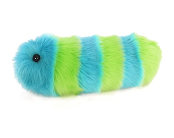 May include: A blue and green striped plush toy shaped like a caterpillar. The toy has a black eye and is made of soft, fuzzy material.