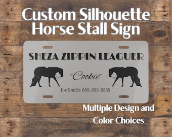 May include: A custom horse stall sign with the text "Custom Silhouette Horse Stall Sign" at the top. The sign features the name "SHEZA ZIPPIN LEAGUER" and the name "Cookie" below it, along with two horse silhouettes. The sign also includes a phone number and the text "Multiple Design and Color Choices."