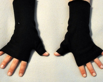 May include: A pair of black fingerless gloves with a thumb hole. The gloves are made of a soft, stretchy fabric.
