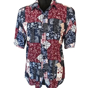 May include: A short-sleeved button-down shirt with a patchwork design. The shirt is made of a soft, lightweight fabric and features a variety of colors and patterns, including red, blue, and white.