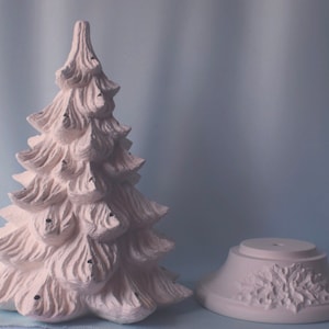 May include: White ceramic Christmas tree with a base. The tree has a textured surface and is ready to be painted.