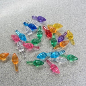 May include: Assortment of colorful plastic Christmas light bulb tips in various colors, including red, blue, green, yellow, and orange.