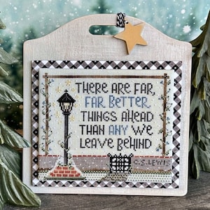 May include: A cross-stitch sampler with a white background and a black and white checkered border. The sampler features a quote: "There are far, far better things ahead than any we leave behind." The sampler also features a small illustration of a street lamp and a fence.