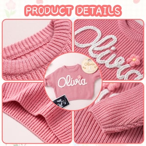 May include: A pink long-sleeve knit sweater featuring the name Olivia embroidered in white yarn across the chest. A small pink flower applique is attached next to the name. The sweater has a ribbed crew neckline, cuffs, and hem.