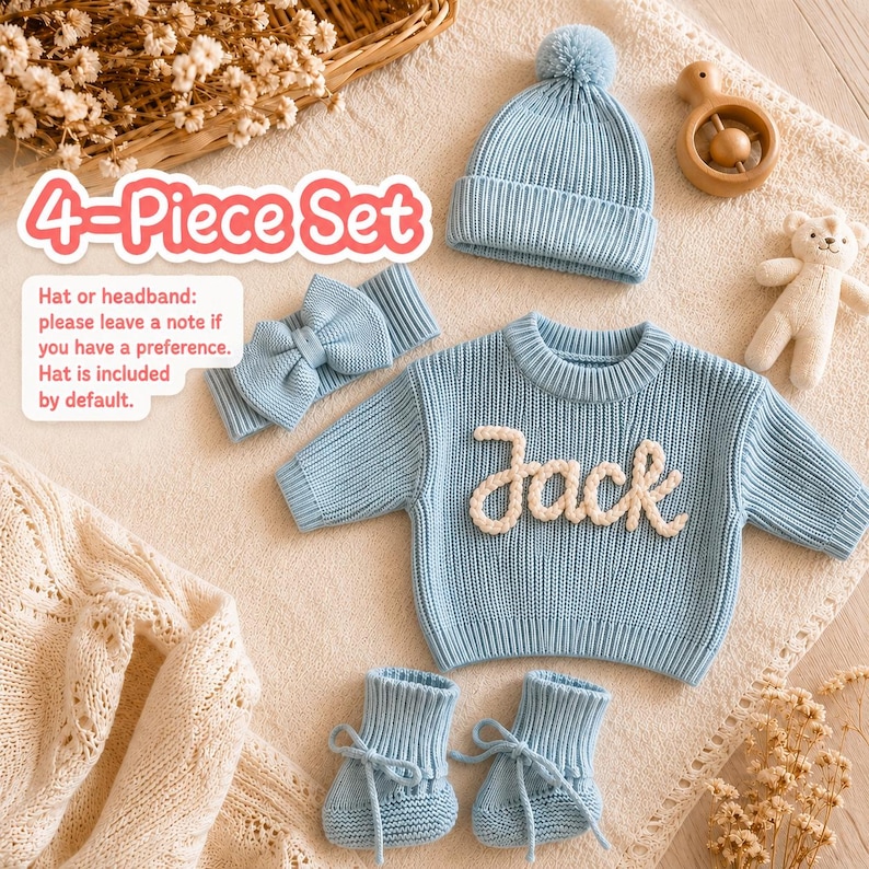 a beautifully curated flat-lay of a dusty blue 4-piece baby sweater gift set, including a chunky-knit sweater customized with the name "Jack" in 3D embroidery, a matching pom-pom beanie (or optional bow headband), and a pair of lace-up booties. Adorned with a plush teddy bear and dried flowers, this premium customized coordinates set serves as an exceptional premium full-month gift from grandparents to a newborn grandson, or as a stunning baby shower surprise for a close friend's baby boy.