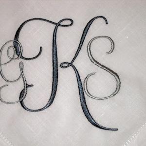 May include: A monogrammed handkerchief with the letters "GKS" embroidered in black and silver thread.
