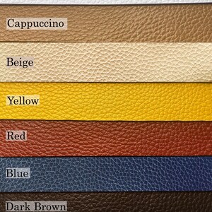 May include: A color chart featuring eight horizontal strips of textured material labeled Choose a color, White, Cappuccino, Beige, Yellow, Red, Blue, Dark Brown, and Black. Each strip displays a distinct solid color with a pebbled surface finish.