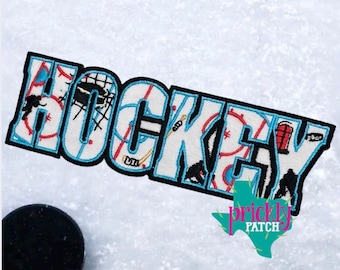 May include: Embroidered patch featuring the word "HOCKEY" in white letters with a light blue outline. The letters are filled with hockey-related graphics in red, black, and white. A black hockey puck is visible.