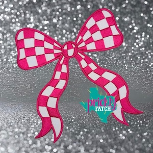 May include: An embroidered patch shaped like a bow with a vibrant hot pink and white checkered pattern. The design features two loops and two long, flowing tails. A teal logo with the text "PRICKLY PATCH" is positioned near the bottom right.