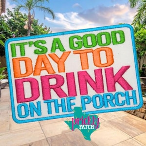 May include: Rectangular white patch with the text "IT'S A GOOD DAY TO DRINK ON THE PORCH" in green, orange, pink, and blue. The patch has a blue border and a Texas-shaped logo.