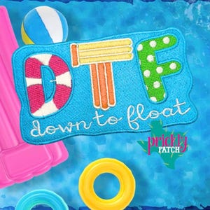 May include: A blue embroidered patch with the text "DTF down to float" and a life preserver, pool float, and beach ball design. The patch has a white border and a green cactus logo.