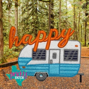 May include: Embroidered patch featuring a blue and white camper with the orange word "happy" above it. The camper has two windows and a door. The background is a forest scene.