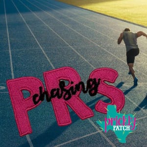May include: A pink embroidered patch with the text "Chasing PRS" on a blue track with a runner in the background. The patch also features a cactus logo with the words "Prickly Patch".