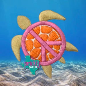 May include: An embroidered patch shaped like a sea turtle with tan flippers and a circular shell featuring an orange and white geometric pattern overlaid with a pink peace sign. A green Texas-shaped logo with the text Prickly Patch is visible.
