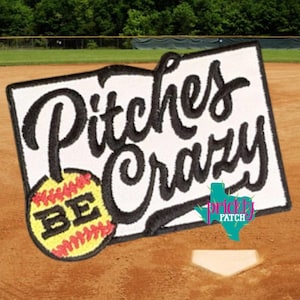 May include: A rectangular embroidered patch with a white background and a black border. The text reads "BE" in black letters on a yellow softball with red stitching, followed by the word "Pitches Crazy" in large, black, cursive script.
