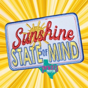 May include: Embroidered patch with the words "Sunshine State of Mind" in red and yellow lettering. The patch features a sun design and a blue border, set against a yellow burst background. The Prickly Patch logo is at the bottom.