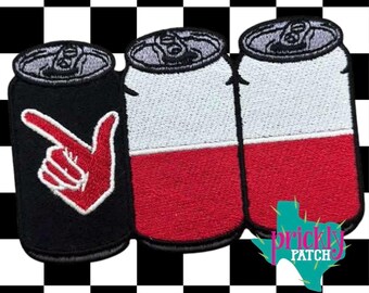 May include: An embroidered patch featuring three beverage cans. The left can is black with a red hand gesture pointing right. The middle and right cans are white on top and red on the bottom. A teal Texas-shaped logo reads Prickly Patch.