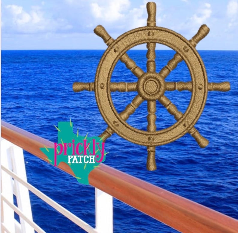 May include: A gold-colored ship's wheel, embroidered with intricate details, set against a backdrop of a blue ocean and sky. The image includes a wooden railing and the text "prickly patch".