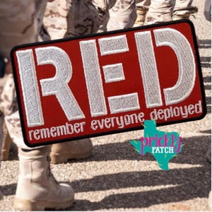 May include: A white ceramic mug with a black handle and the text "But First, Coffee" in a black, handwritten-style font. The mug is on a white surface.