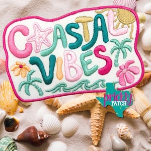 May include: An embroidered patch with a white background and a bright pink border featuring the text Coastal Vibes in colorful, puffy-style lettering. The design includes stitched icons of a starfish, a sun, palm trees, and flowers.