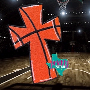 May include: An orange basketball-themed cross patch with black lines and white trim. The patch is set against a blurred background of a basketball court and a basketball hoop. The Prickly Patch logo is visible.