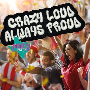 May include: Black embroidered patch with the words "CRAZY LOUD ALWAYS PROUD" in white, wavy lettering. The patch is in front of a crowd of cheering people, with the Prickly Patch logo at the bottom.