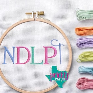 May include: A wooden embroidery hoop holds white fabric with the embroidered letters "NDLP" in blue, pink, and green. A needle and thread are also embroidered. The Prickly Patch logo is in the lower right corner. Colorful embroidery floss is to the right.