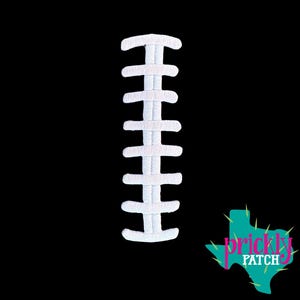 May include: A white embroidered patch featuring the vertical laces of an American football, set against a solid black background. In the bottom right corner, there is a teal-colored logo shaped like the state of Texas with the text Prickly Patch.