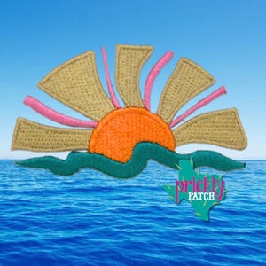 May include: An embroidered patch featuring a stylized orange sun rising over a dark teal wavy horizon line. The sun has tan rays interspersed with thin pink lines. A teal Texas-shaped logo with the text prickly PATCH is visible.