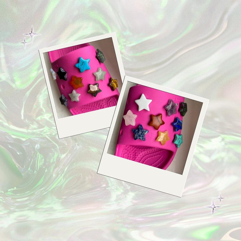 May include: Two pink slides decorated with star-shaped gemstones in various colors, including white, blue, orange, and black. The slides are presented in a polaroid-style frame against a shimmering, iridescent background.