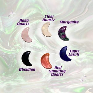 May include: An assortment of crescent-shaped gemstones, including Rose Quartz, Clear Quartz, Morganite, Obsidian, Red Smelting Quartz, and Lapis Lazuli. Each stone is labeled with its name in a stylized font. The background has a swirling, iridescent effect.