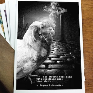 May include: Black and white art print featuring a smoking goat with a street sign that reads "DESCA" and "2300". The quote "The streets were dark with something more than night" by Raymond Chandler is also included.