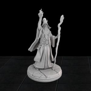 May include: A grey painted miniature figurine of a wizard with a long white beard, wearing a robe and holding a staff and a flaming orb. The wizard is standing on a circular base with a stone-like texture.