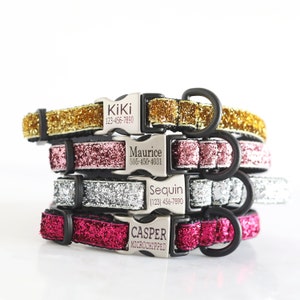 May include: Stack of four sparkly dog collars in gold, pink, silver, and red with personalized engraved name tags. The collars are made of glitter fabric and have black buckles.