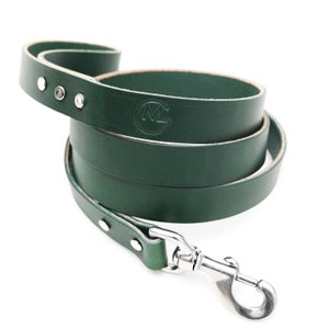 May include: A dark green leather dog lead with a silver clip and a small embossed logo.