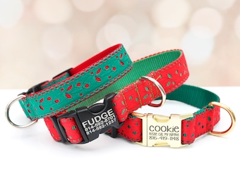 May include: Three personalized dog collars in red and green. One collar has the name "Fudge" and a phone number on the black buckle. Another collar has the name "Cookie" and a phone number on the gold buckle. The collars have metal D-rings.