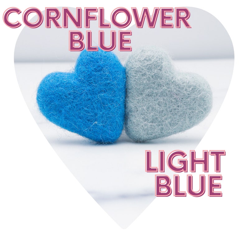 May include: Two felt hearts, one cornflower blue and one light blue. The hearts are side by side on a white surface.