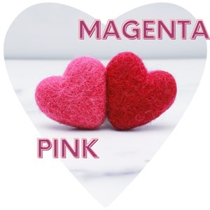 May include: Two felt hearts, one pink and one magenta, on a white marble surface. The word "PINK" is written in pink below the hearts, and the word "MAGENTA" is written in magenta above the hearts.