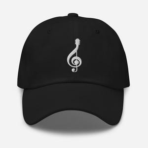May include: A black baseball cap with a white embroidered treble clef.