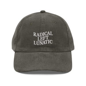 May include: A dark green corduroy baseball cap with white embroidered text that reads "RADICAL LEFT LUNATIC".