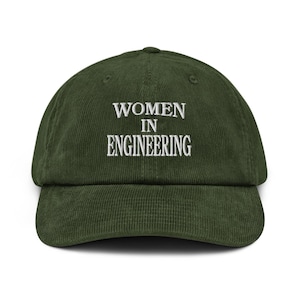 May include: A dark green corduroy baseball cap with the text "WOMEN IN ENGINEERING" embroidered in white. The cap has a curved brim and an adjustable strap at the back.