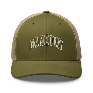 May include: A green and tan trucker hat with a white embroidered design that says "GAME DAY".