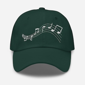 May include: A dark green baseball cap with a white embroidered design of musical notes on a treble clef.
