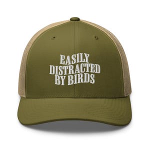May include: A green and brown trucker hat with the text "EASILY DISTRACTED BY BIRDS" embroidered in white.